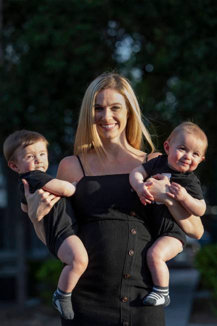 Shannon Belford pose for a portrait with her 9-month-old twin sons, Gavin and Garrett, outside ...