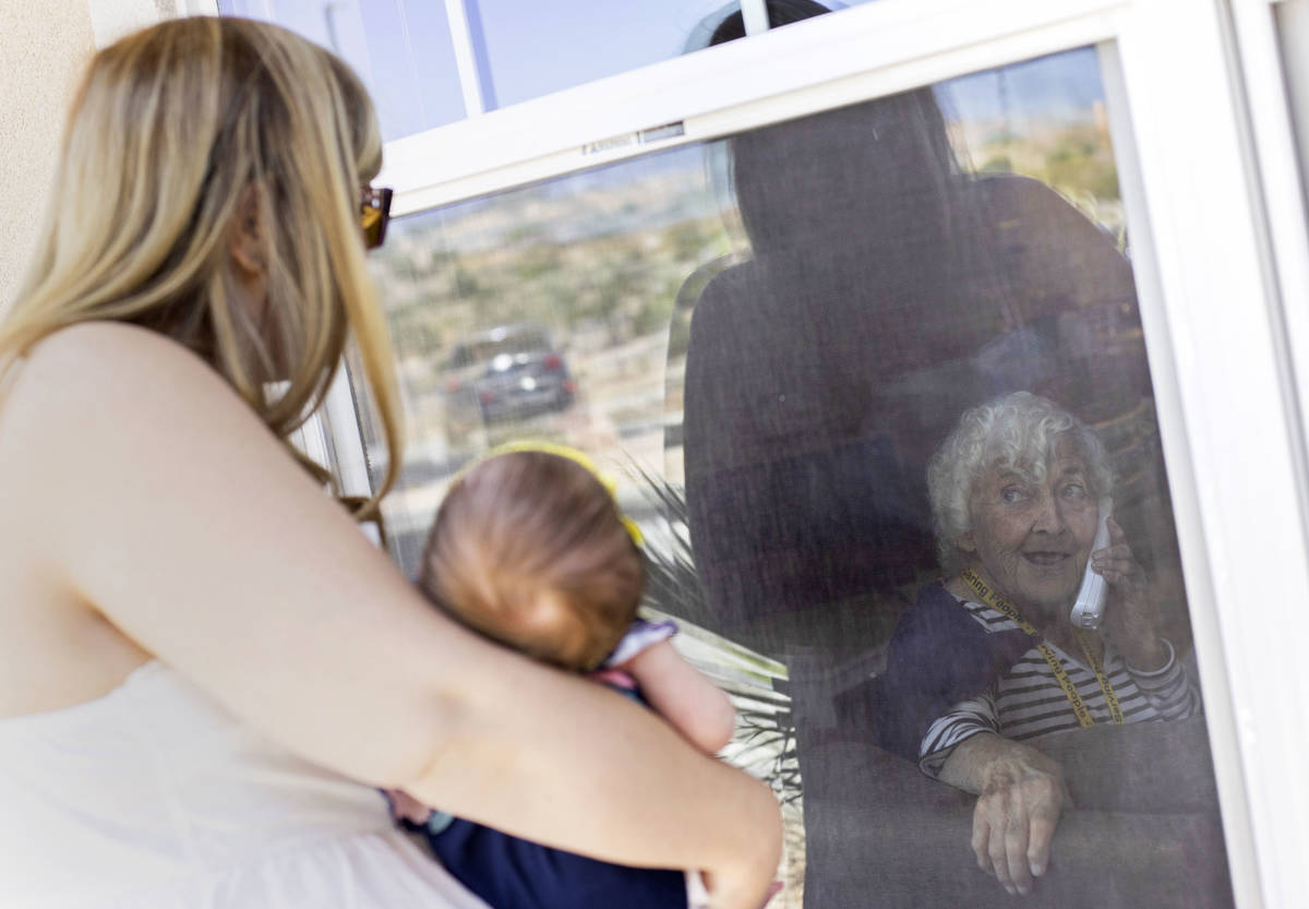 June Watkins, 97, beams at her one-month-old great granddaughter, Eliana, as her granddaughter ...