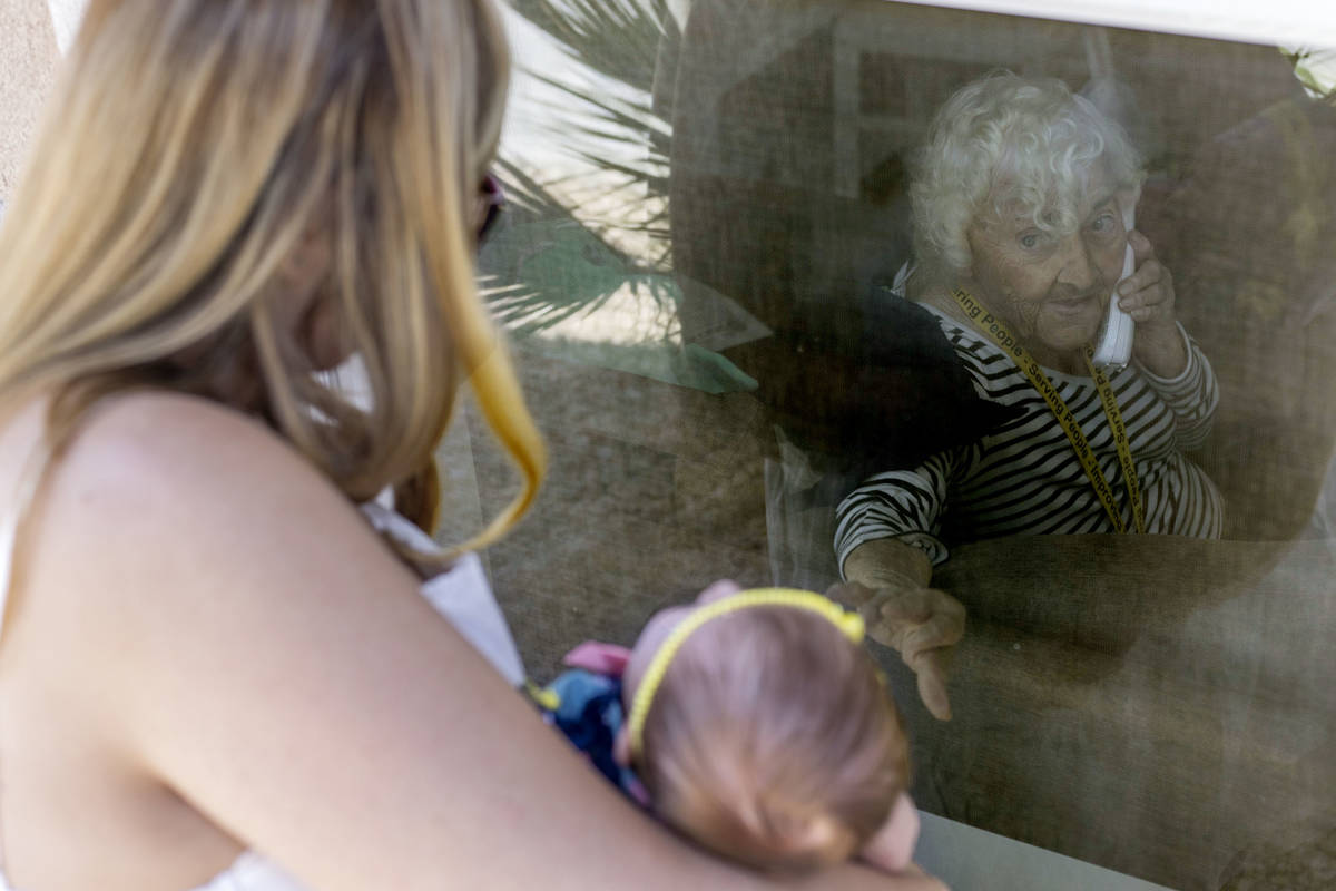 June Watkins, 97, reaches out for her one-month-old great granddaughter, Eliana, as her grandda ...