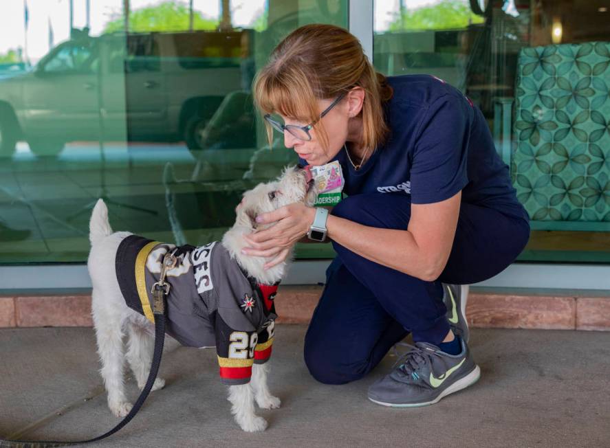 Clinical supervisor Stephanie Aceto receives a kiss from Bark-Andre Furry while he wears a Gold ...