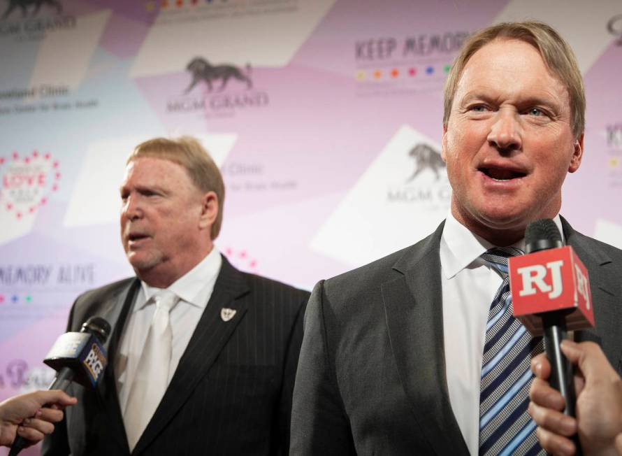 Raiders head coach Jon Gruden, right, and Raiders owner Mark Davis talk with the media on the r ...