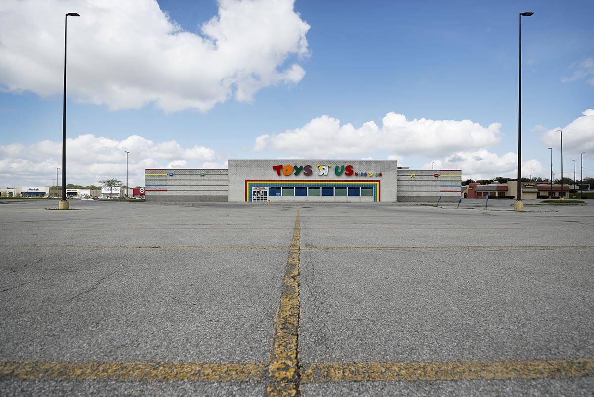 A closed Toys R Us building sits in front of an empty parking lot, Wednesday, May 6, 2020, in D ...