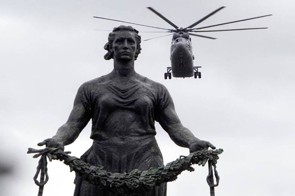 A Mi-26 military helicopter flies over a statue of the Mother Motherland at the Piskaryovskoye ...