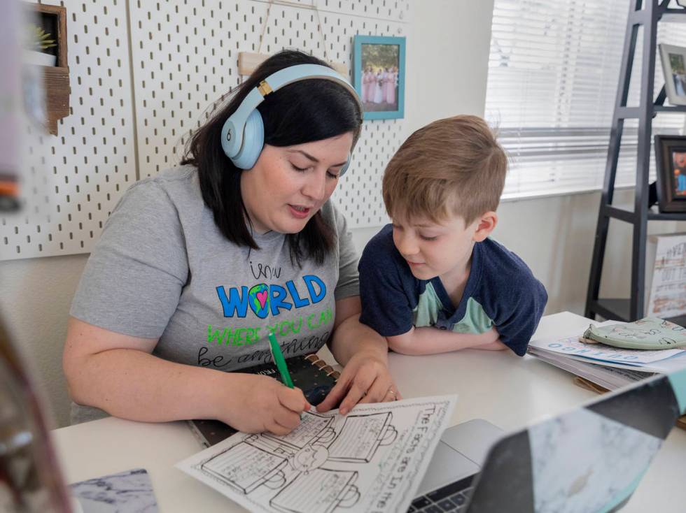 School counselor for Jerome Mack Middle School Jessica Houchins, left, helps her son Everett Ma ...