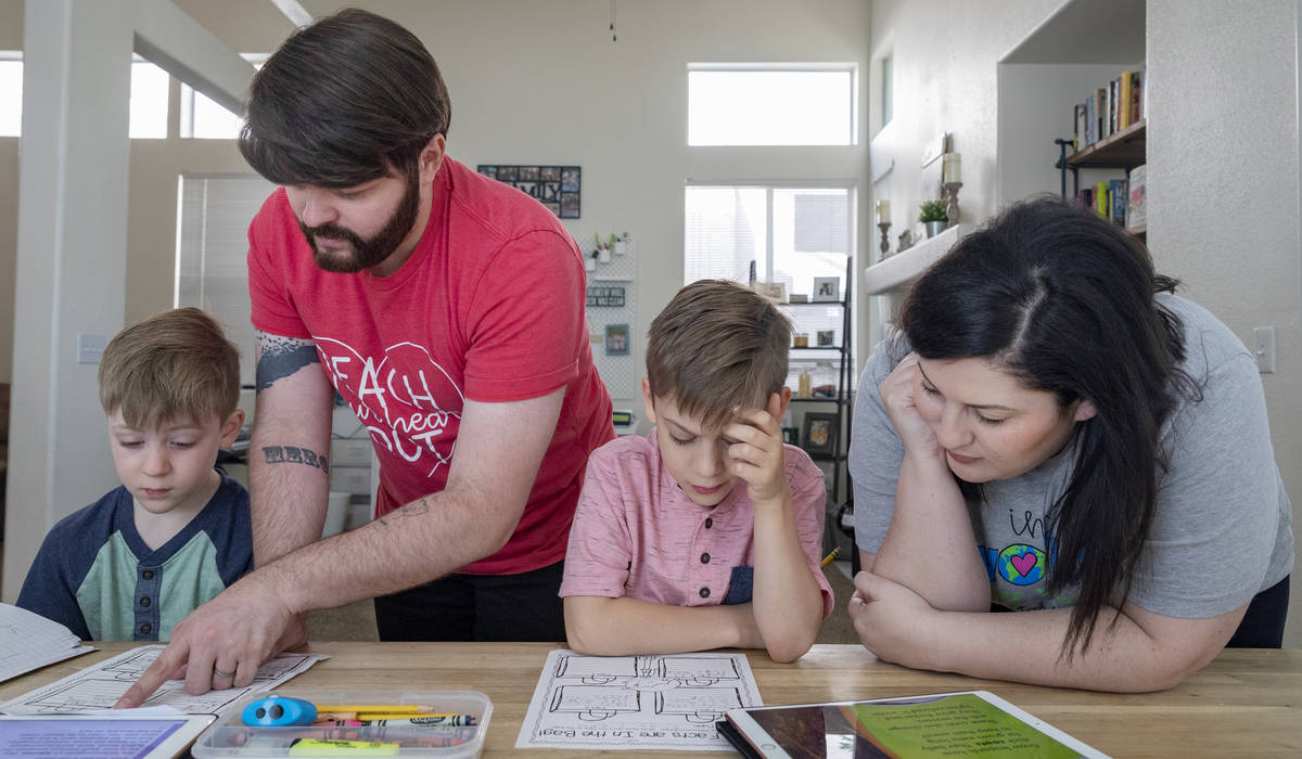 From left, Everett Mayville, 7, Christopher Houchins, a kindergarten teacher, Atticus Mayville, ...