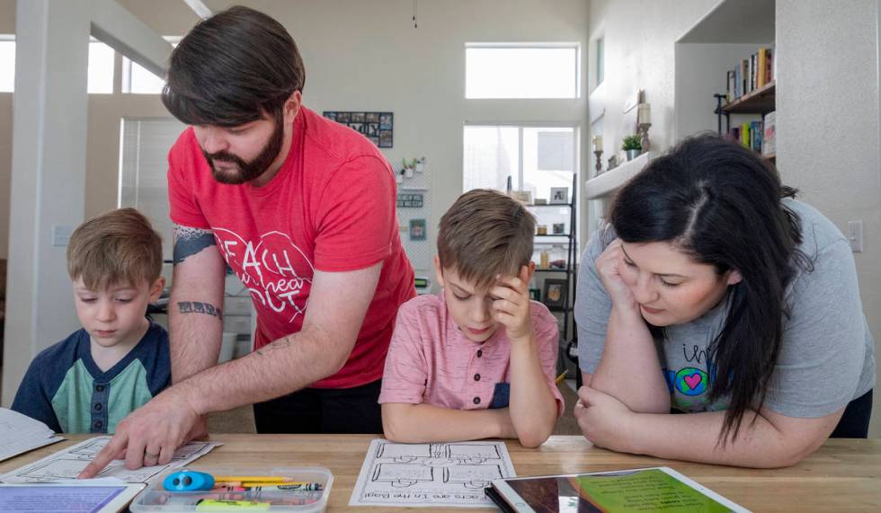 From left, Everett Mayville, 7, Christopher Houchins, a kindergarten teacher, Atticus Mayville, ...