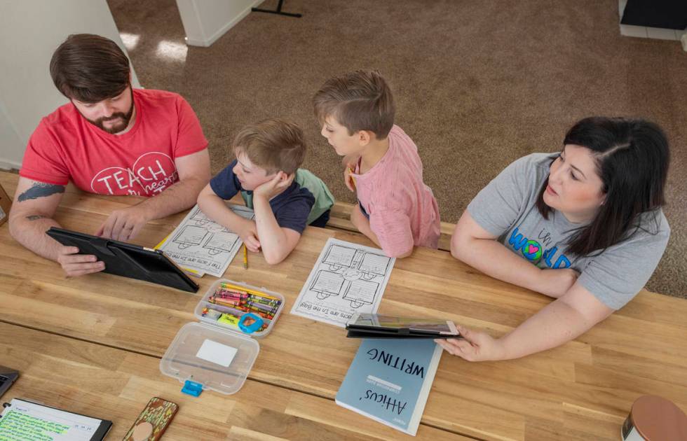 From left, Everett Mayville, 7, Christopher Houchins, a kindergarten teacher, Atticus Mayville, ...