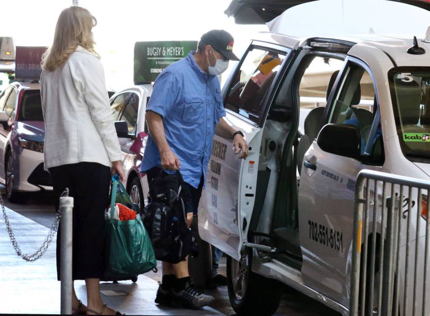 Arriving passengers at McCarran International Airport take a taxi on Thursday, May 7, 2020, in ...