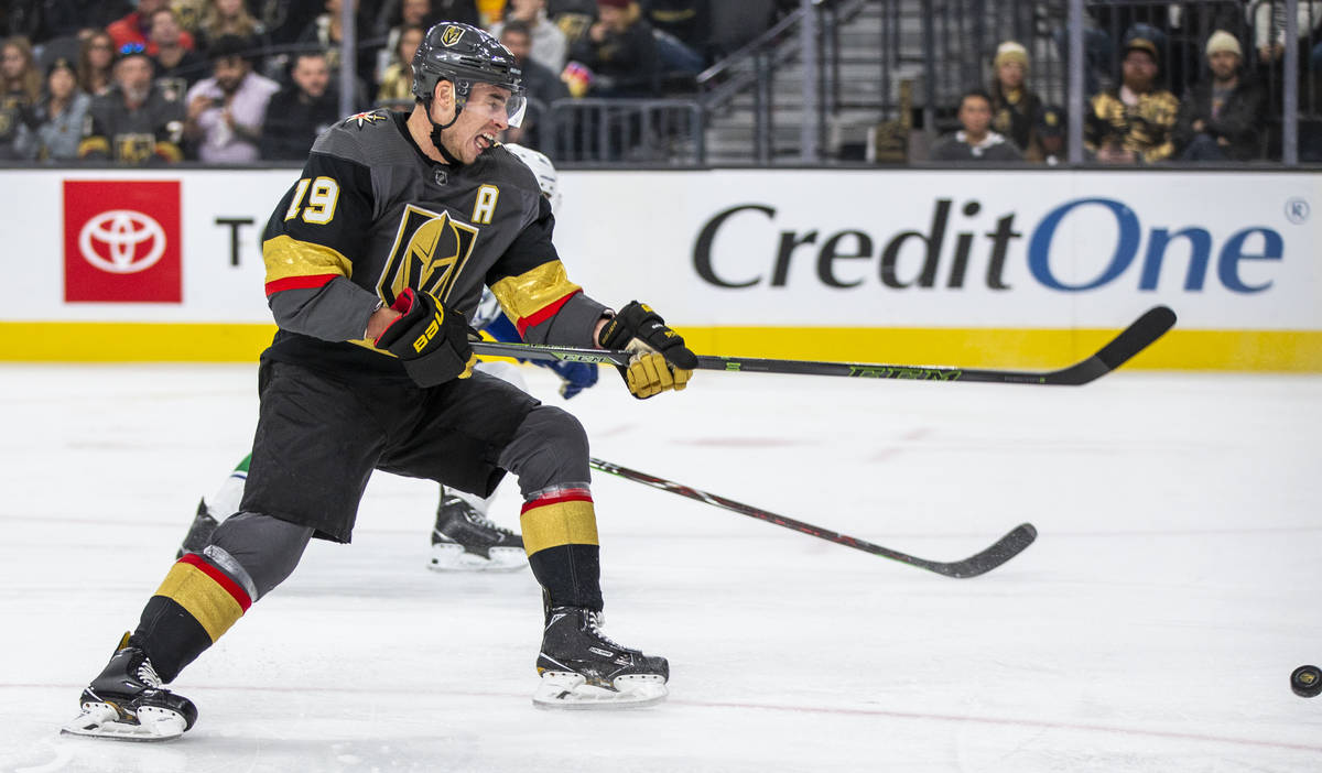 Vegas Golden Knights right wing Reilly Smith (19) gets off a shot over the Vancouver Canucks du ...