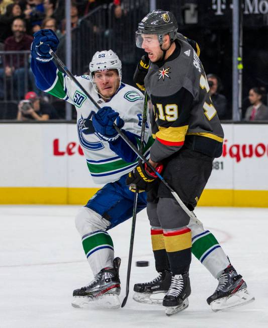 Vancouver Canucks center Bo Horvat (53, left) crashes into Vegas Golden Knights right wing Reil ...