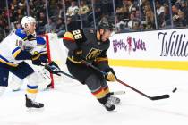 Golden Knights' Paul Stastny (26) eyes the puck in front of St. Louis Blues' Jay Bouwmeester (1 ...