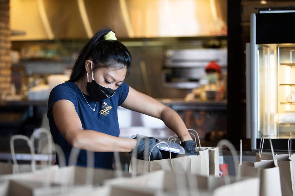 Juliana Asa fills a to-go order at Nora's Italian Cuisine on Wednesday, May 6, 2020, in Las Veg ...