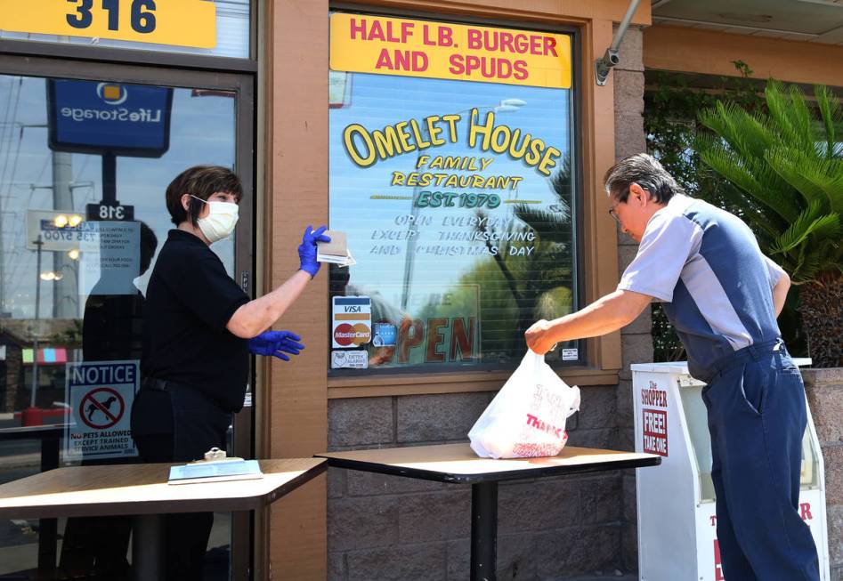 Shi, who declined to give his last name, picks up his order from Terri Labree, a waitress, at a ...