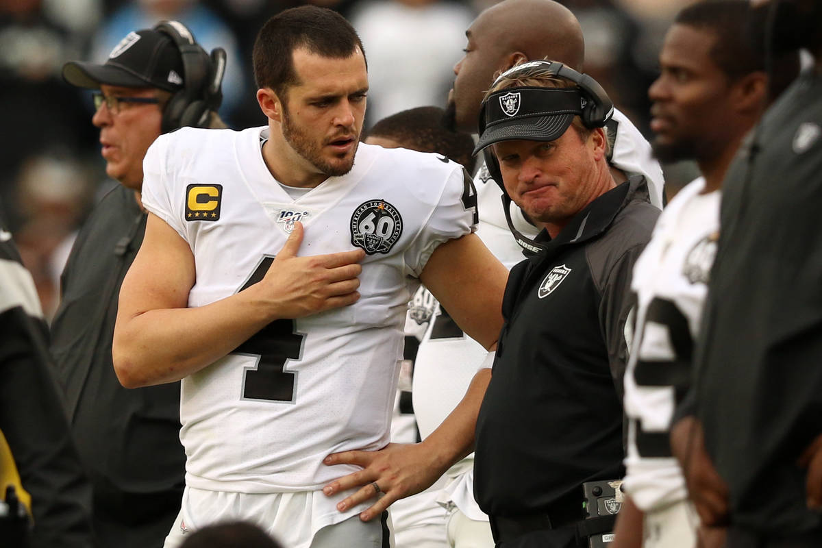 Oakland Raiders quarterback Derek Carr (4) speaks with head coach Jon Gruden on the sideline du ...