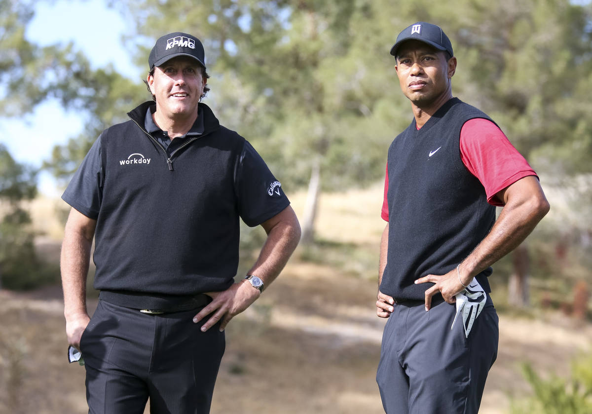 Phil Mickelson, left, and Tiger Woods stand at the first tee box before The Match at Shadow Cre ...