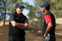 Phil Mickelson, left, and Tiger Woods talk at the first tee before a golf match at Shadow Creek ...