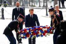 French President Emmanuel Macron lays a wreath of flowers during a ceremony to mark the 75th an ...