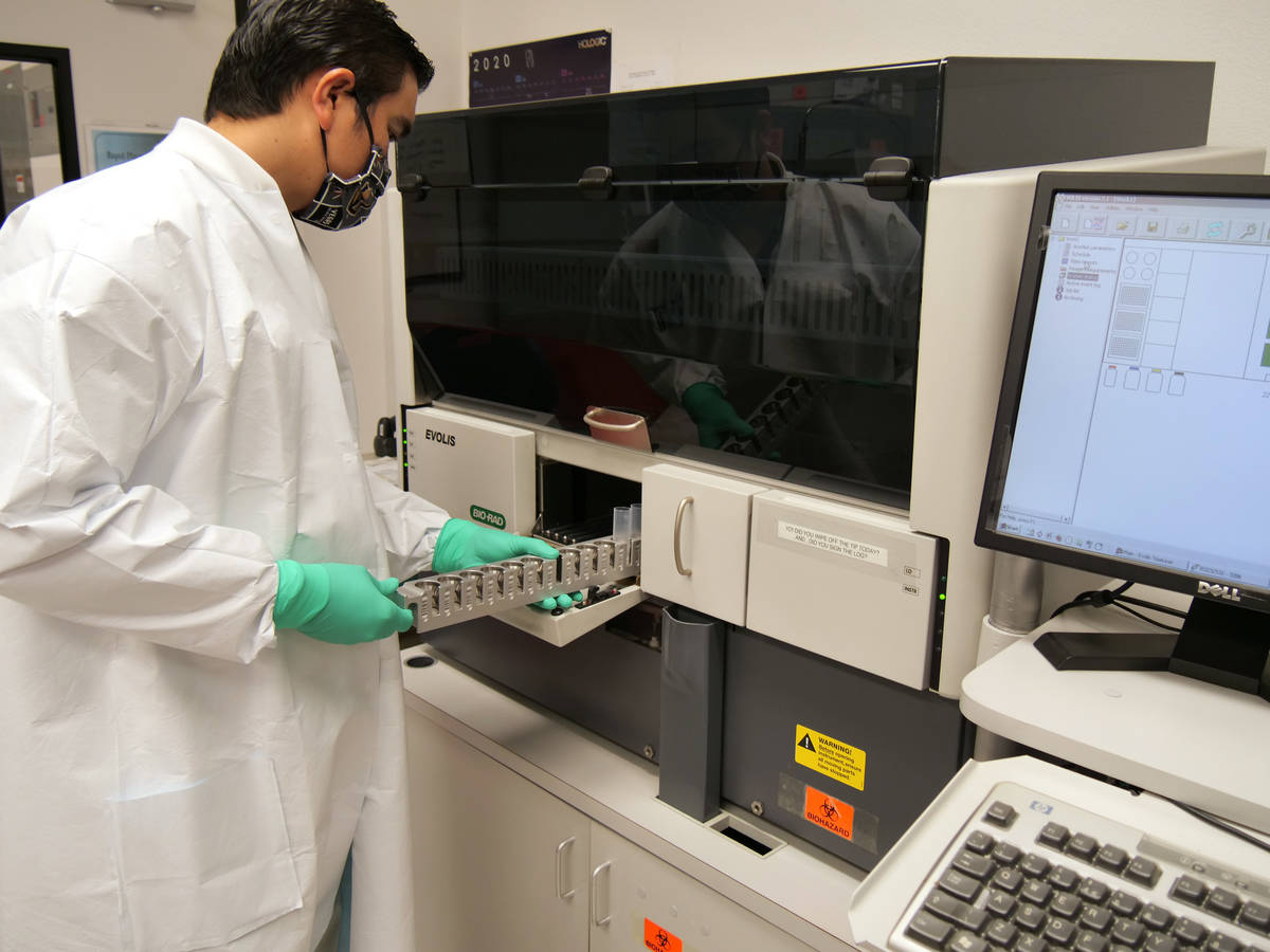 Nick Gabler, laboratory supervisor at the Southern Nevada Public Health Laboratory, demonstrate ...