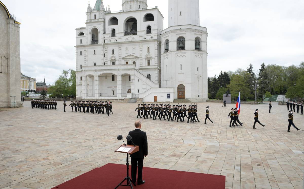 Russian President Vladimir Putin, back to a camera, watches the honour guard of the Presidentia ...