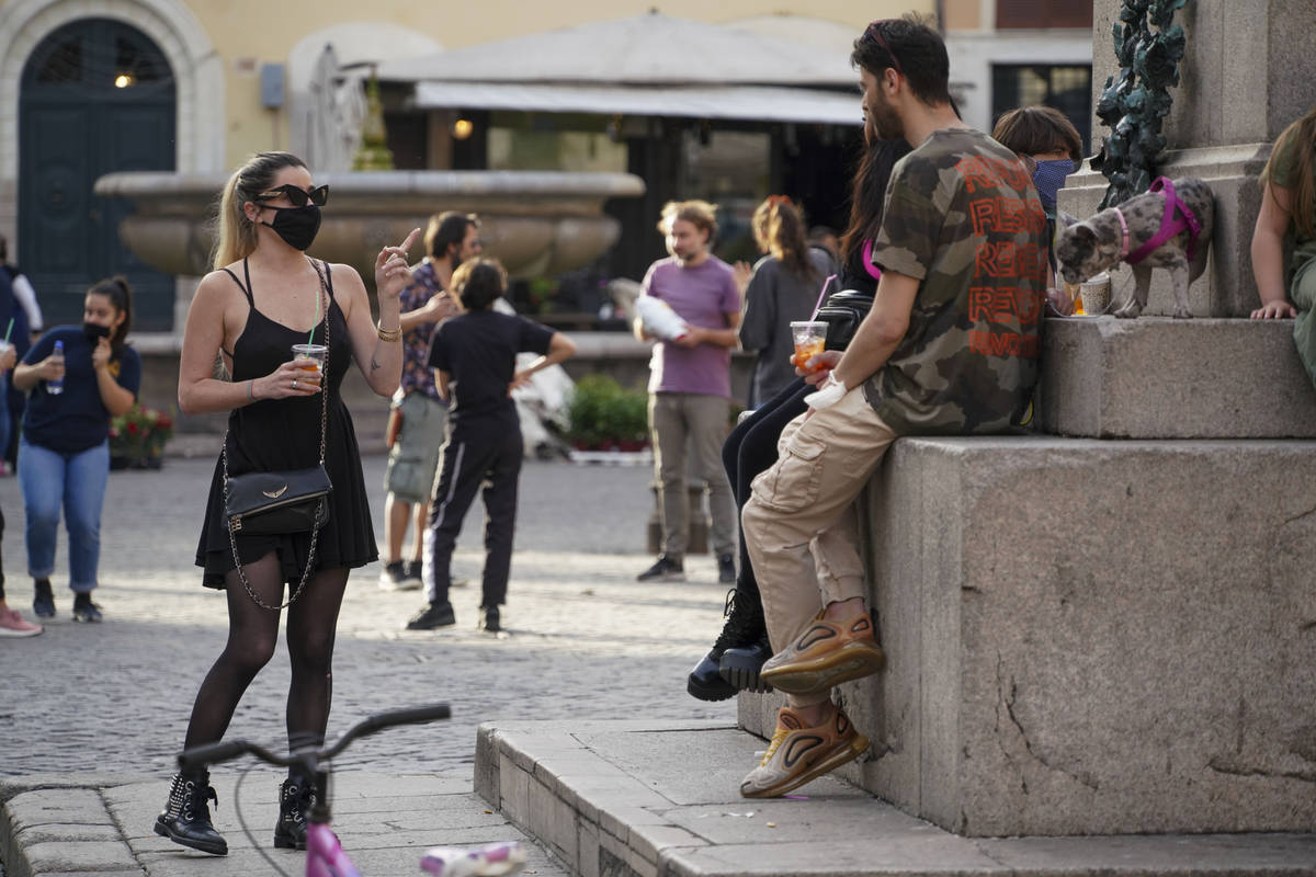 People enjoy a drink in Rome's fashionable Campo De' Fiori Square, as the city is slowly return ...