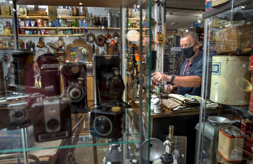 Seller Mark Storm readies the items in one of his stalls for sale within the Antique Alley Mall ...