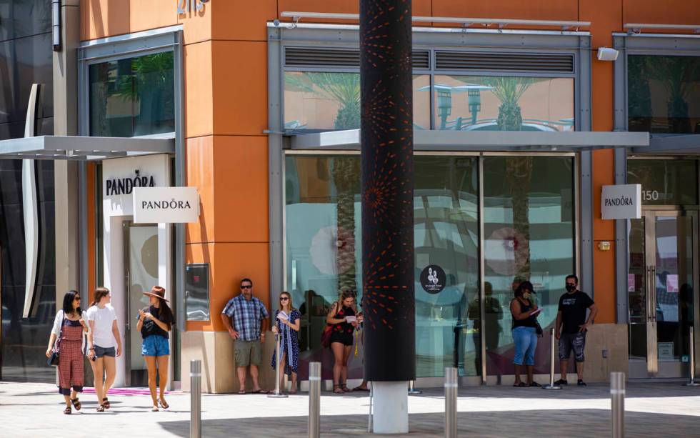 People gather outside of Pandora at Downtown Summerlin as some restaurants and businesses open ...