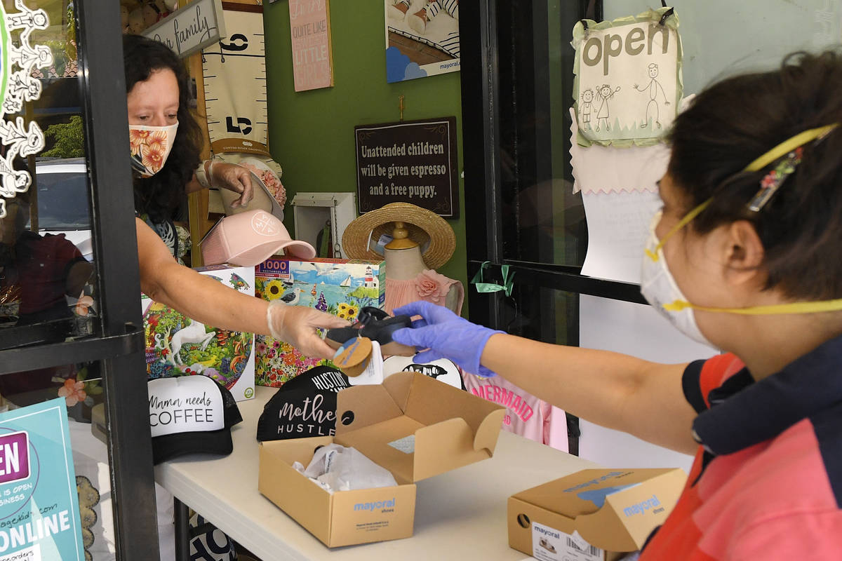 Gigi Garcia, left, helps customer Narineh Ab at "it takes a village kids" during the ...