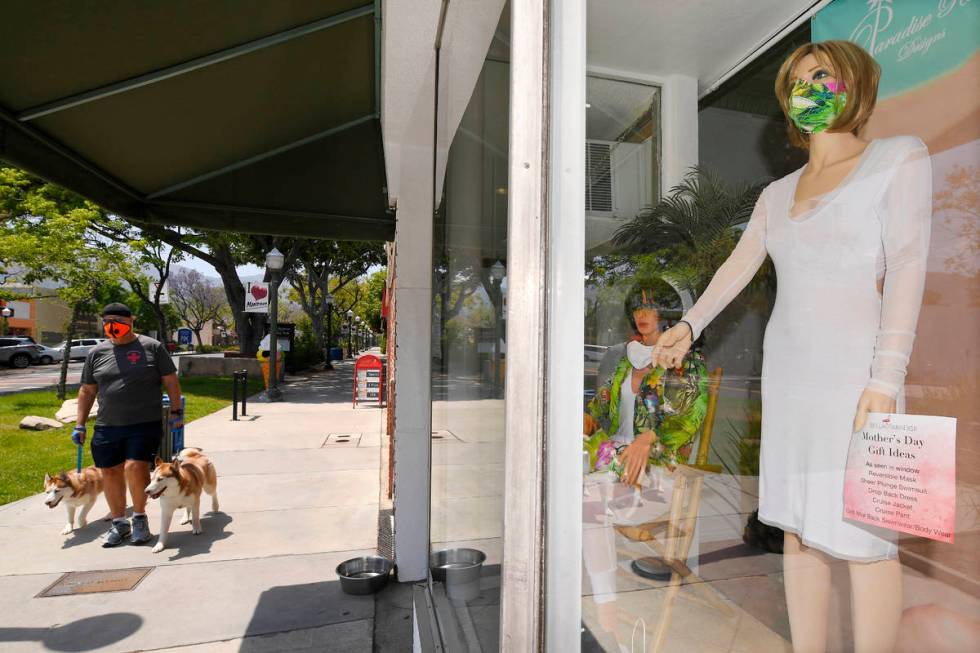 A pedestrian walks by the storefront of Bella Paradise which just reopened during the coronavir ...