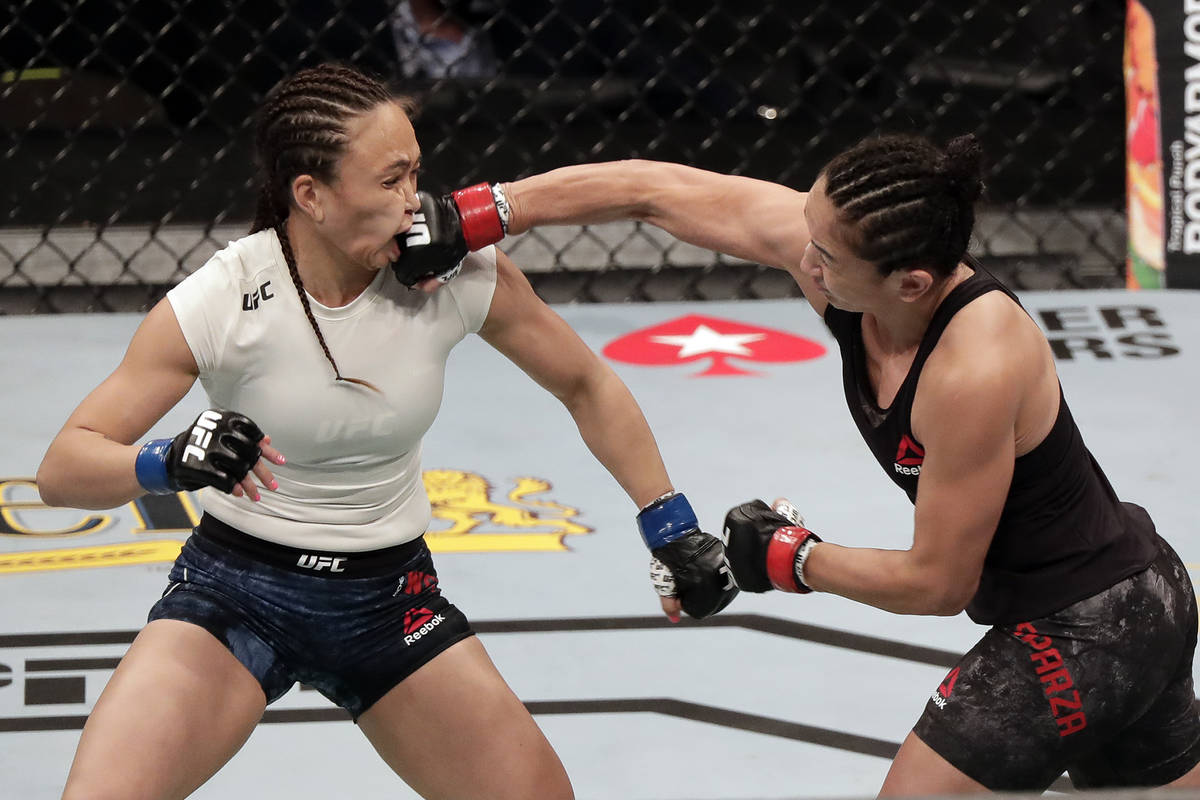 Carla Esparza, right, lands a punch on Michelle Waterson during a UFC 249 mixed martial arts bo ...