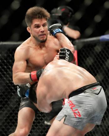 Henry Cejudo, left, throws a punch at Dominick Cruz during a UFC 249 mixed martial arts bout, S ...