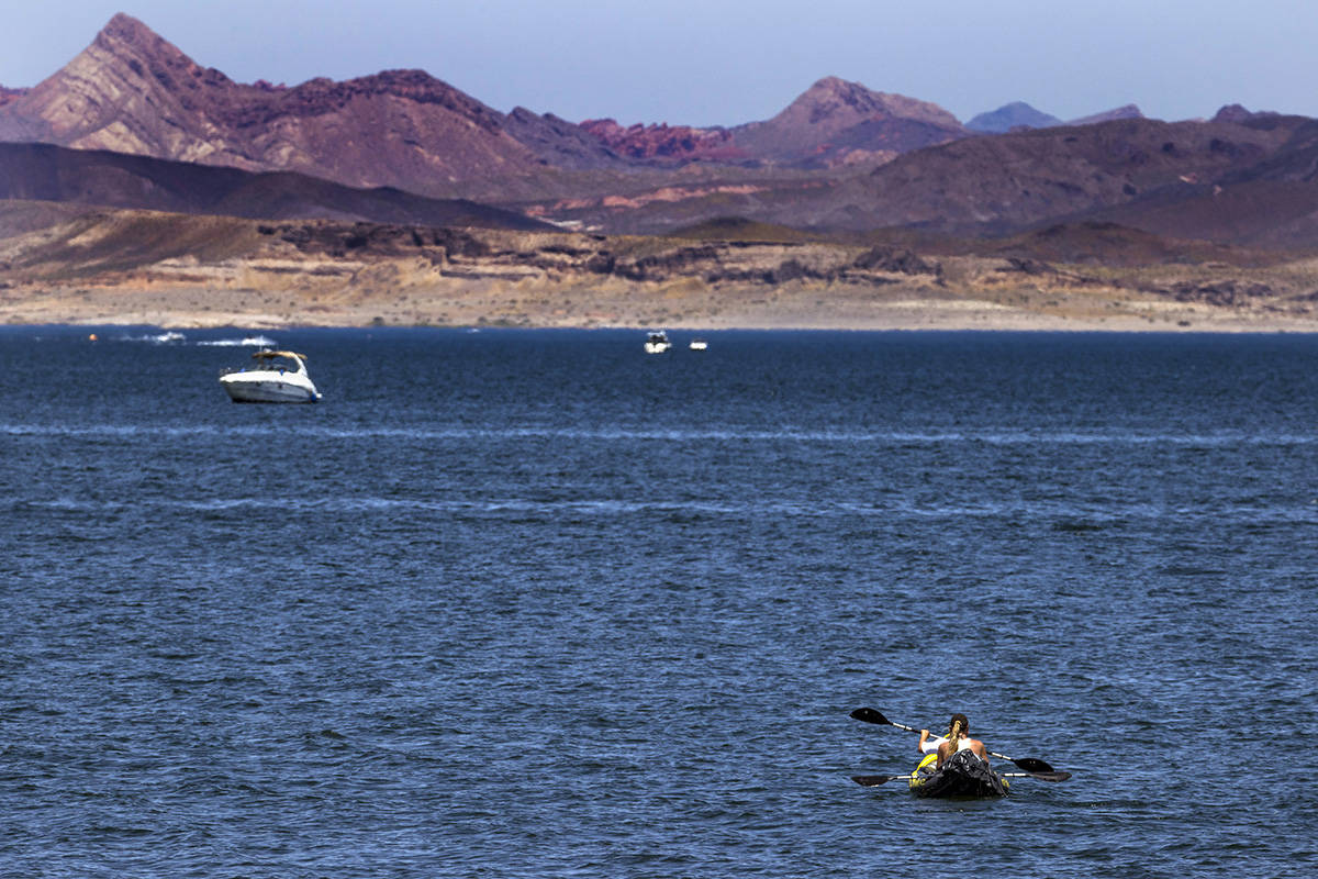 Kayakers paddle to deeper water in the Lake Mead National Recreation Area which is now open to ...