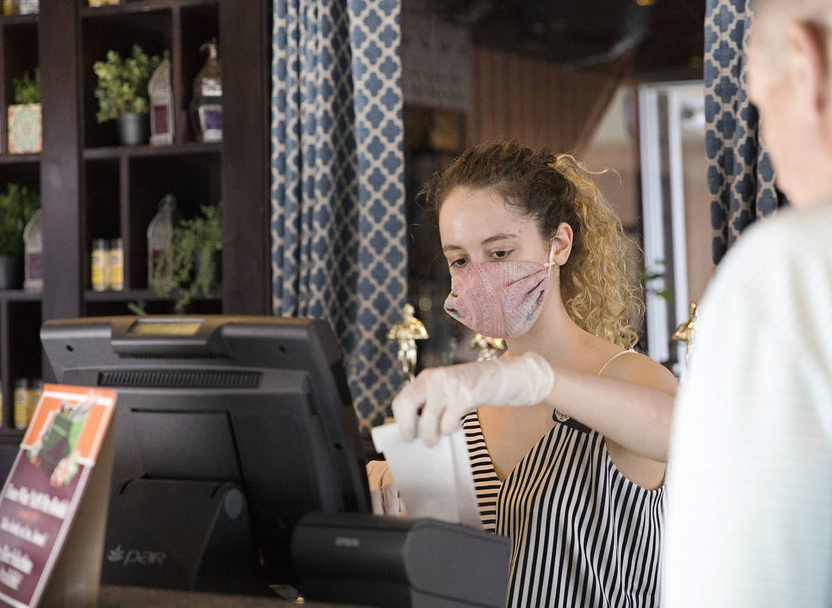 Clea Ciccone helps a customer at Paymons, a Mediterranean restaurant, in Las Vegas, Sunday, May ...