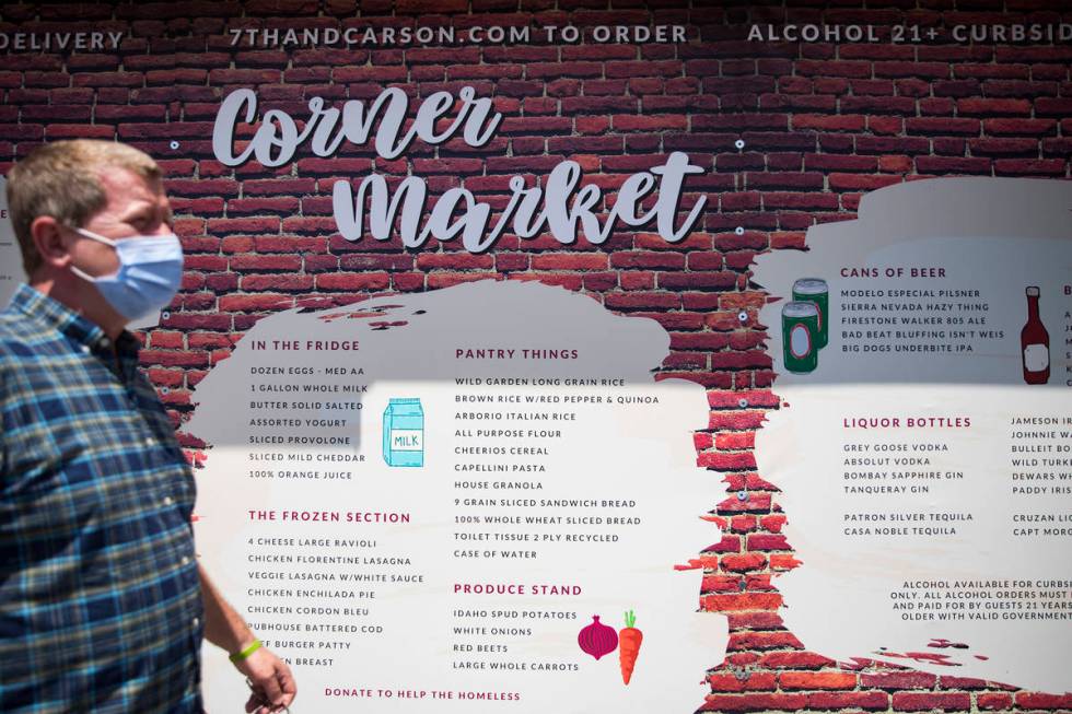 Owner Liam Dwyer walks past a giant menu at 7th & Carson in Las Vegas, Sunday, May 10, 2020 ...