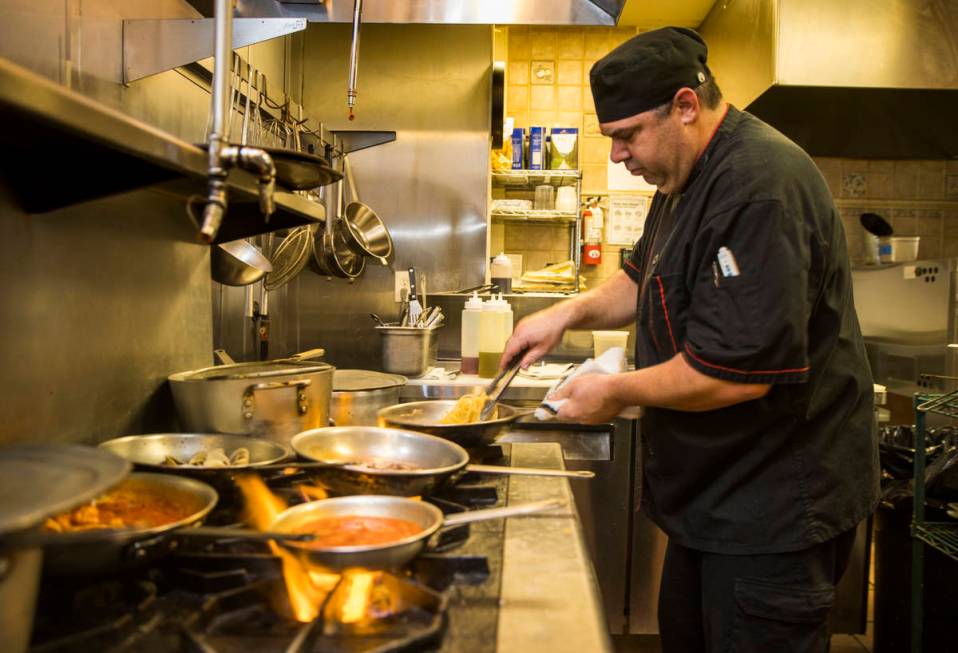 Che and owner Dan Thompson prepares another dish in the kitchen at D'Agostino's Trattoria on Mo ...