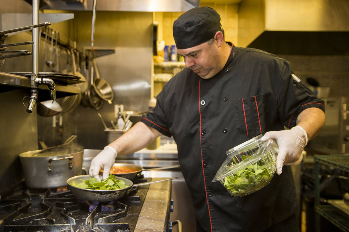 Che and owner Dan Thompson prepares another dish in the kitchen at D'Agostino's Trattoria on Mo ...