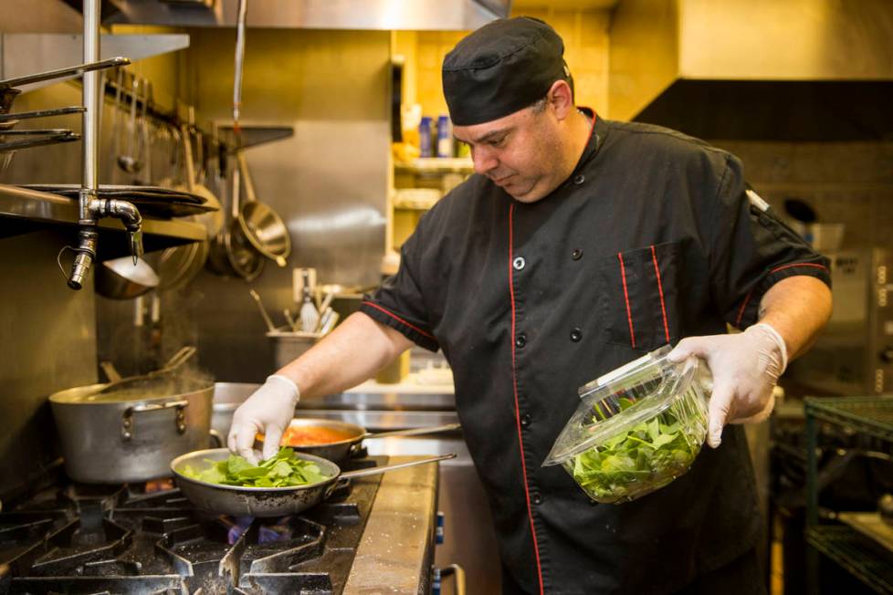 Che and owner Dan Thompson prepares another dish in the kitchen at D'Agostino's Trattoria on Mo ...