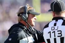 Oakland Raiders head coach Jon Gruden discusses a penalty call with down judge Danny Short (113 ...