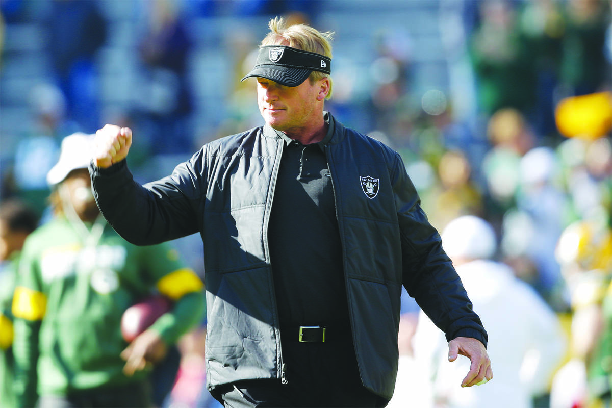 Oakland Raiders head coach Jon Gruden watches warm ups before an NFL football game against the ...