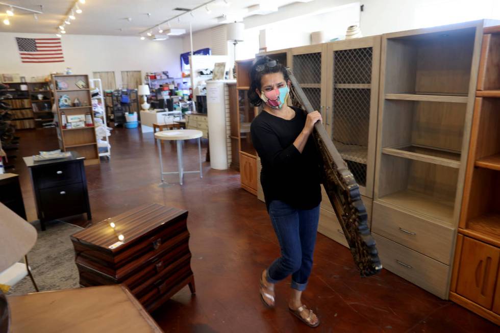 Dinosaurs & Roses customer Lucy Leija, 48, loads a mirror on the first day of reopening for ...