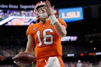 Clemson quarterback Trevor Lawrence celebrates after scoring during the first half of a NCAA Co ...
