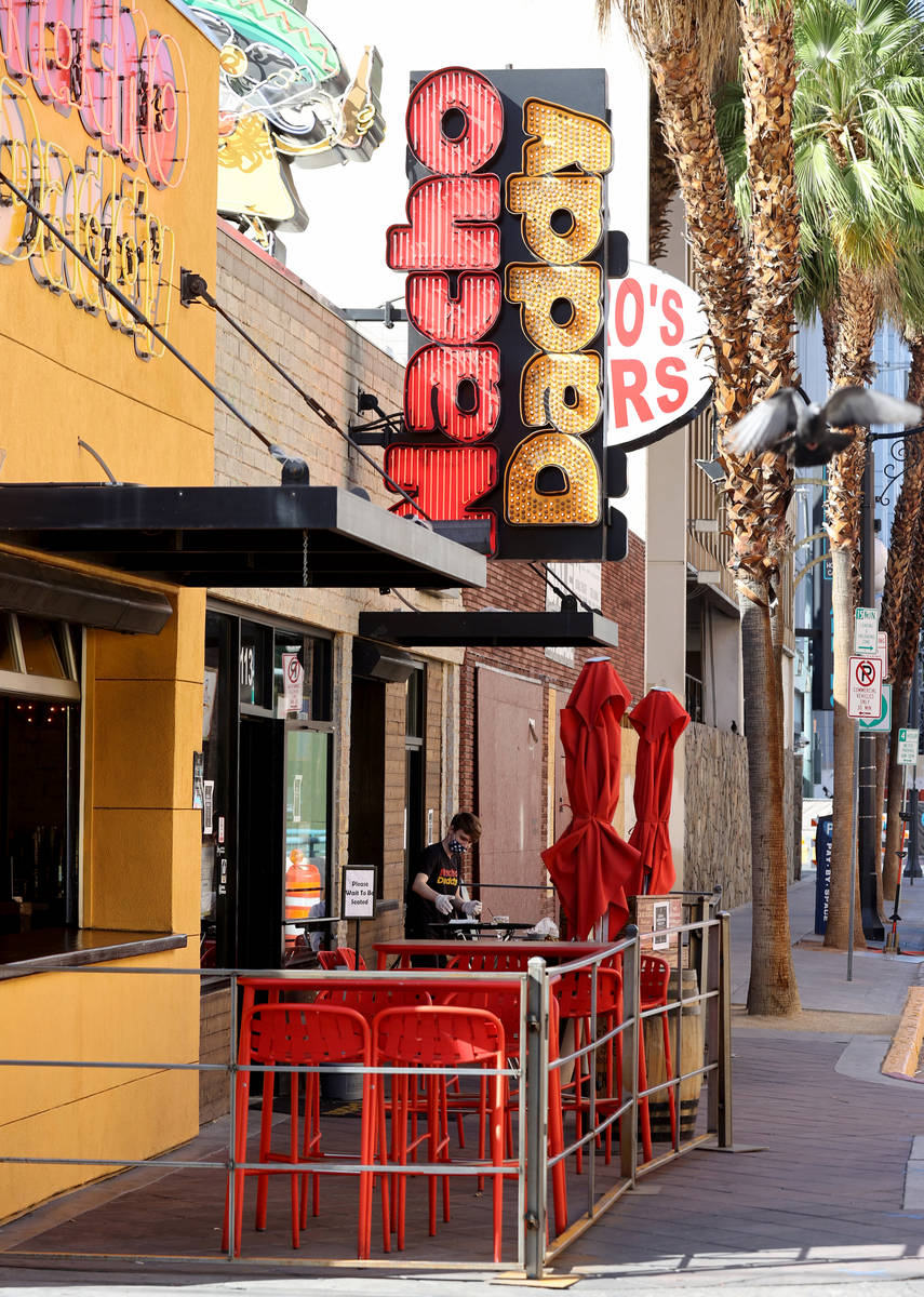 A Nacho Daddy worker serves customers at the restaurant on 4th Street in downtown Las Vegas Tue ...