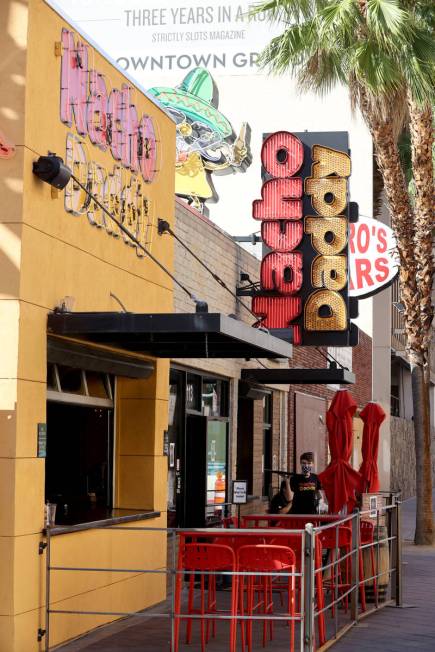 A Nacho Daddy worker serves customers at the restaurant on 4th Street in downtown Las Vegas Tue ...