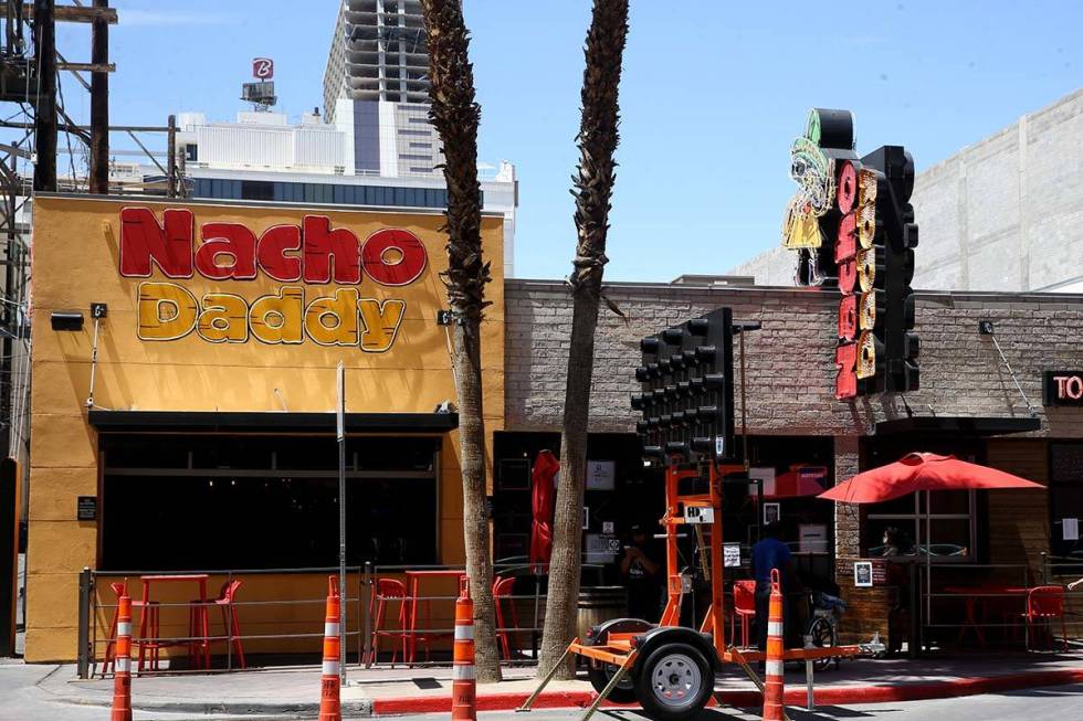 A Nacho Daddy worker returns after delivering a curbside order at the restaurant on 4th Street ...