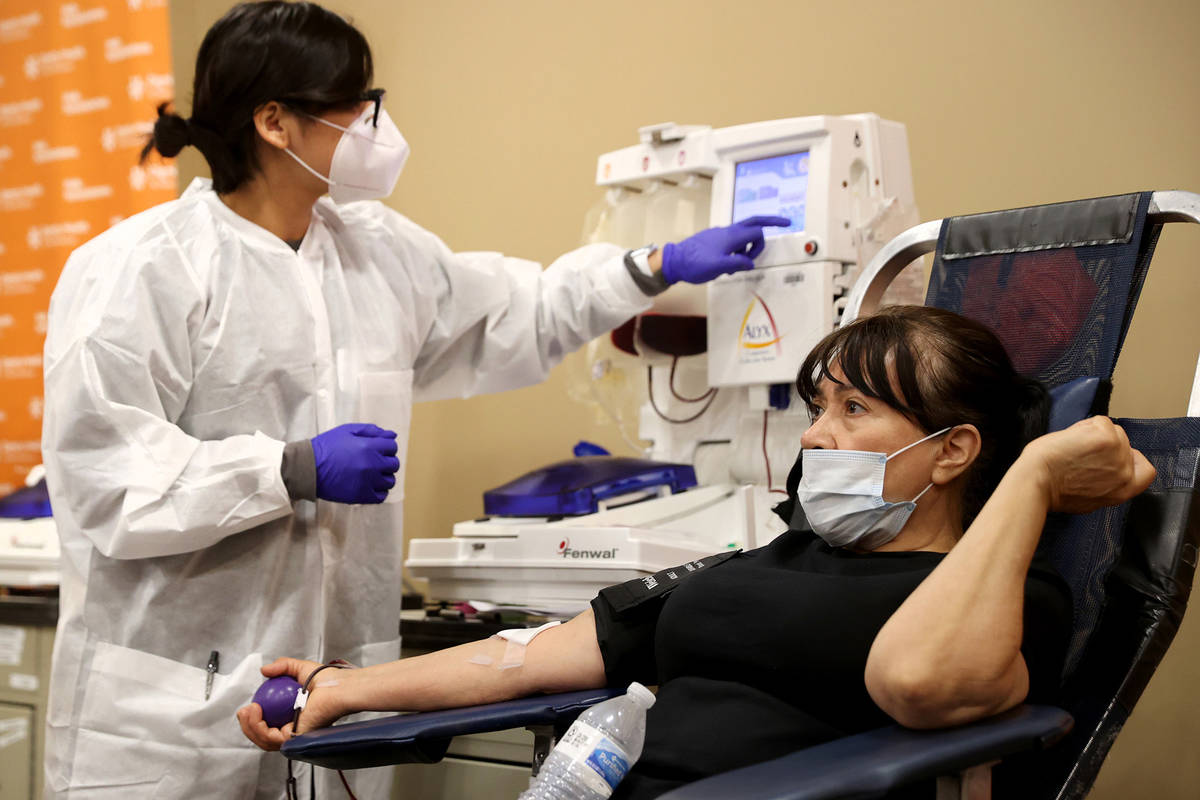 Josefina Garcia, 66, of Las Vegas donates plasma with donor care specialist Genesis Luna at St. ...