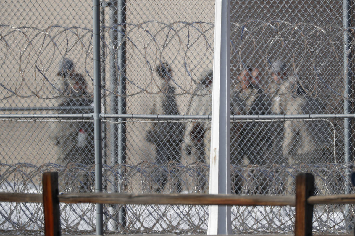 FILE - In this Feb. 18, 2020, file photo, prisoners stand outside the federal correctional inst ...