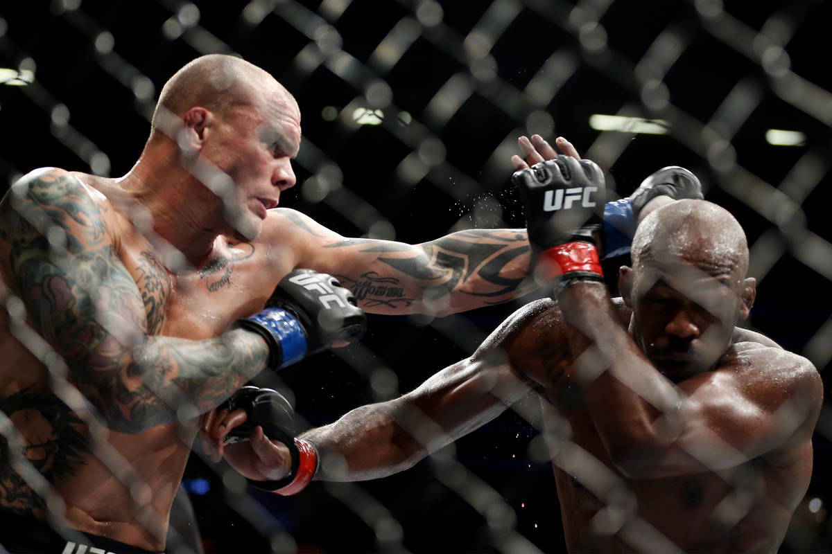 Anthony Smith, left, throws a punch against Jon Jones in the light heavyweight title bout durin ...