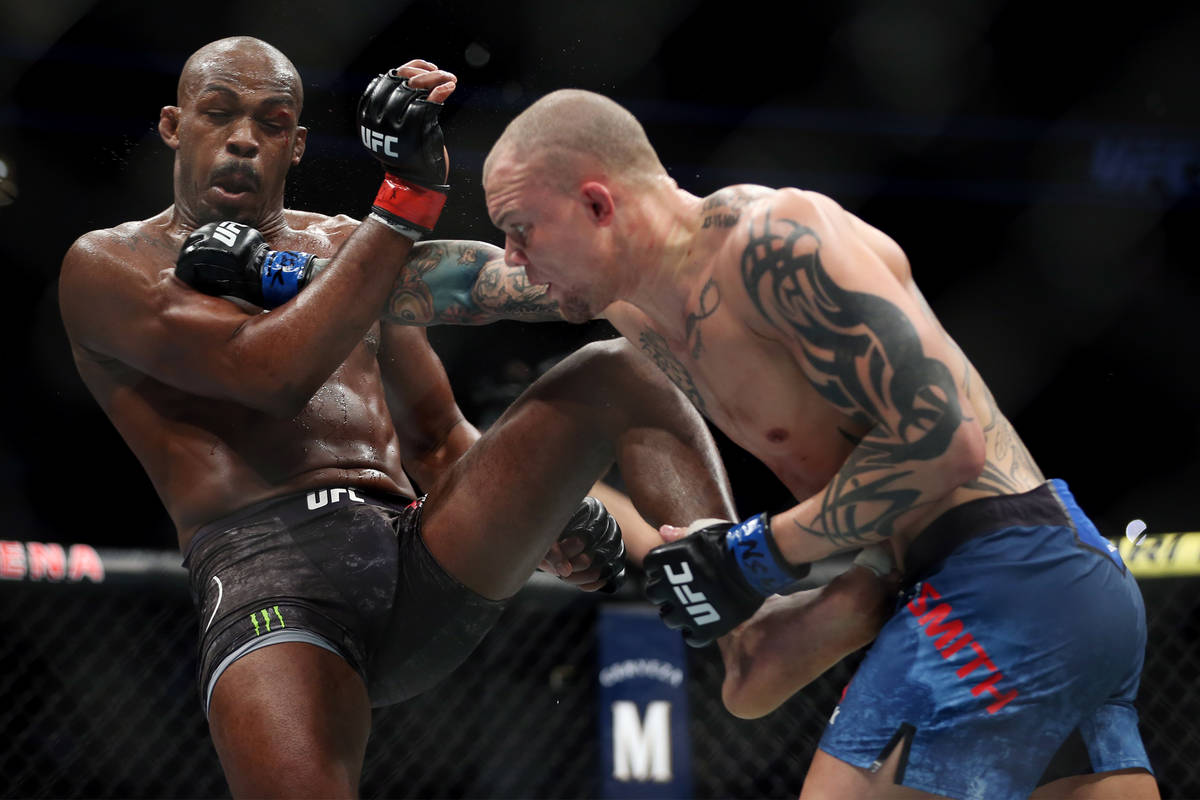 Jon Jones, left, battles Anthony Smith in the light heavyweight title bout during UFC 235 at T- ...