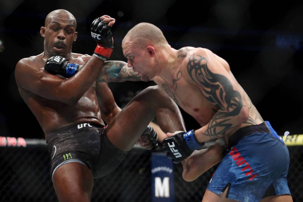 Jon Jones, left, battles Anthony Smith in the light heavyweight title bout during UFC 235 at T- ...