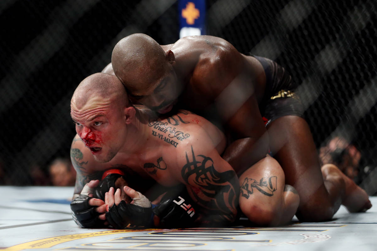 Jon Jones, top, fights Anthony Smith in the light heavyweight title bout during UFC 235 at T-Mo ...