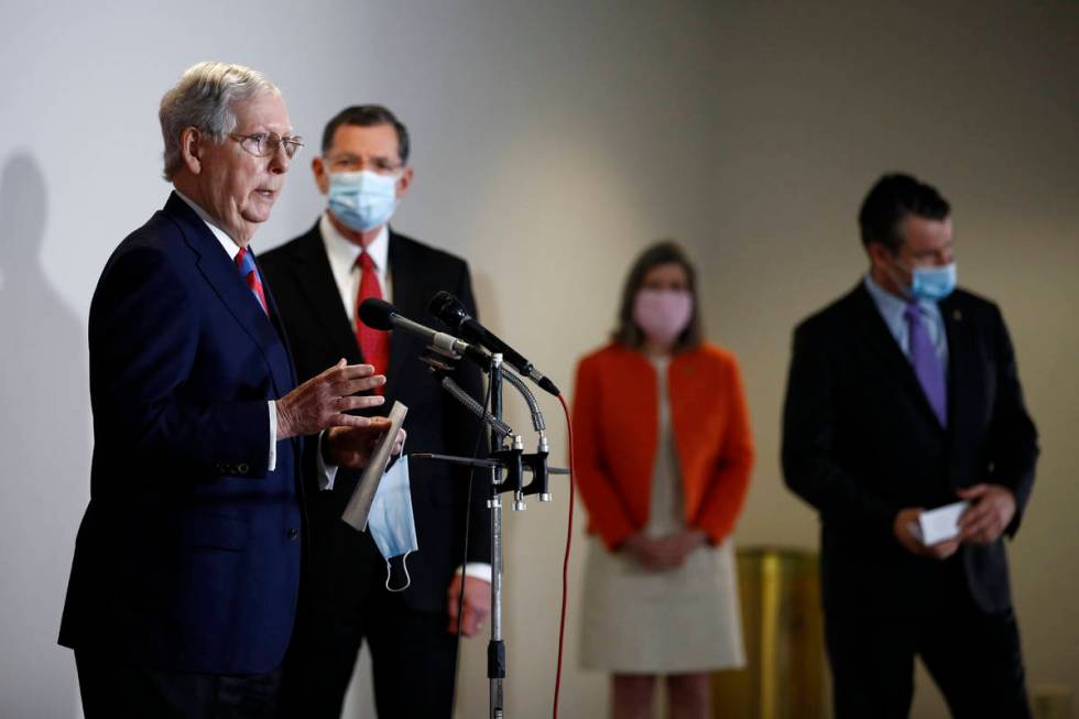 Senate Majority Leader Mitch McConnell of Ky., left, speaks at a news conference on Capitol Hil ...